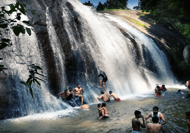Tourist Enjoying the Waterfall