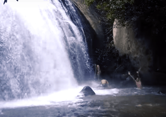 Travelers playing in Anayadikuthu Waterfall