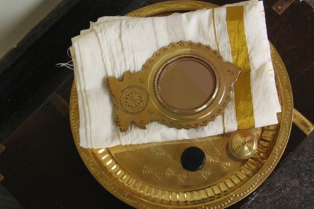 Authentic Aranmula metal mirror from Kerala, a premium souvenir loved by Kerala tour packages tourists.