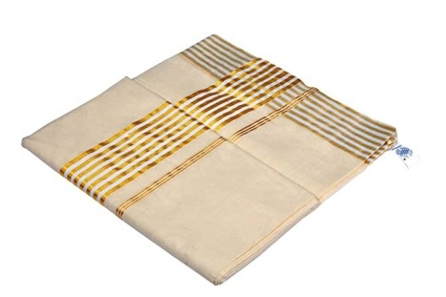 Elegant white-and-gold Kerala Kasavu saree, often purchased by tourists on Kerala tour packages.