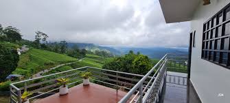 Comfortable resort room in Munnar with balcony overlooking tea gardens