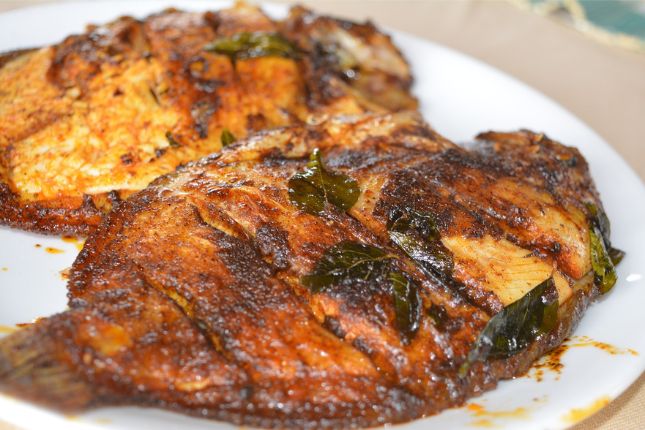 Grilled pearl spot fish wrapped in banana leaf – Kerala seafood delicacy