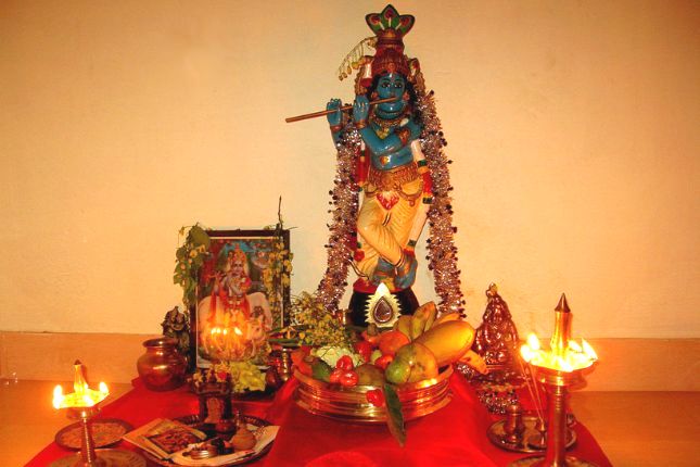 Vishu Kani arrangement with fruits, mirror, and flowers in Kerala home